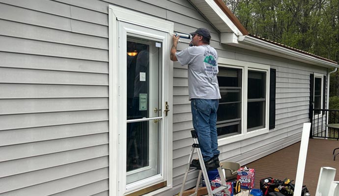 Expert installing a Spectrum Storm Door at a residential property