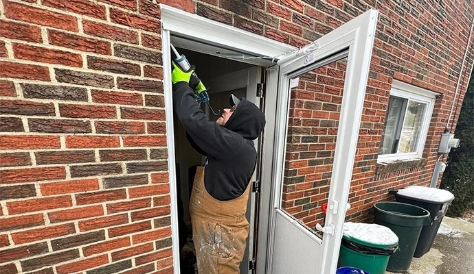 Professional worker installing a storm door