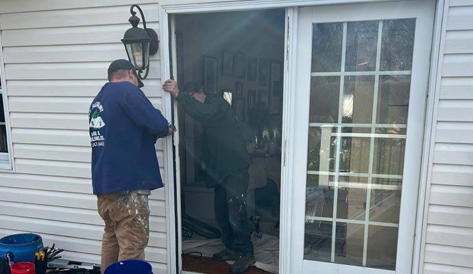 Professionals installing Sliding patio door at a residential house