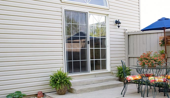 Residential sliding patio door installed at the backyard of a house for outdoor access