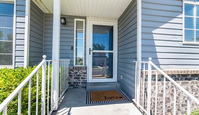 Residential property featuring a white Spectrum Storm Door at the main entrance