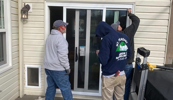 Professional team installing a Sliding patio door at a residential property