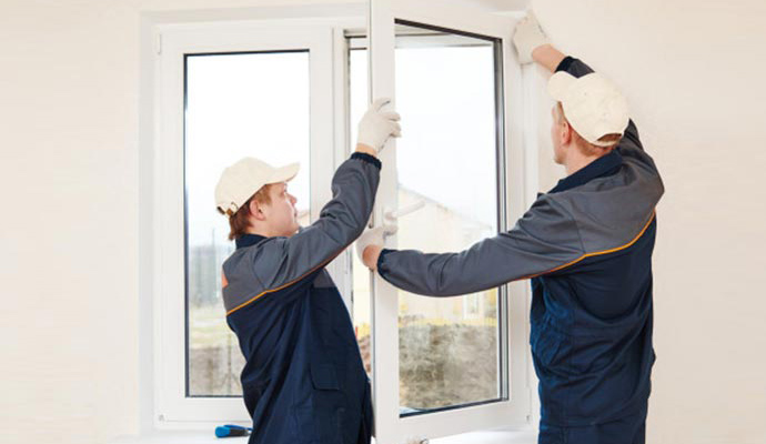 Expert worker installing vinyl window