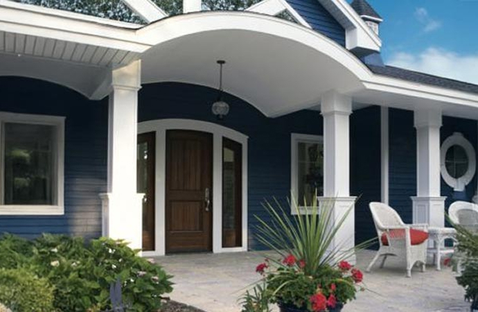 Mastic Ventura™ vinyl siding in deep blue installed on an elegant home exterior