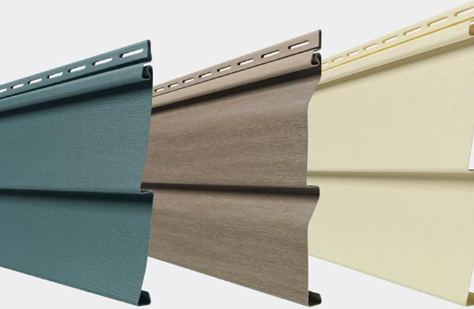 Three Mastic Quest™ vinyl siding panels in green, brown and pale yellow shades displayed side by side
