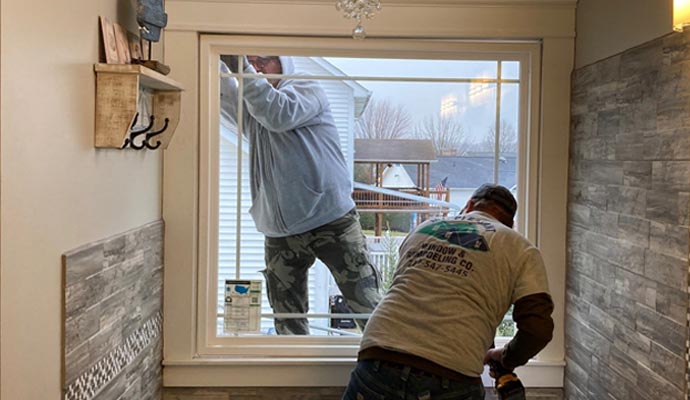 Two people are installing window