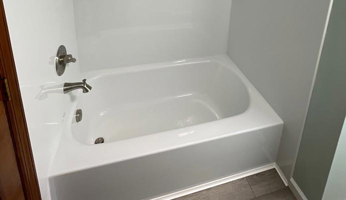 White bathtub with silver faucet and shower handle in a modern bathroom